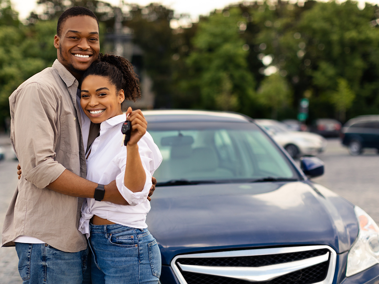 Happy African Couple Showing New Car Key Hugging Standing Outdoors by Prostock-studio