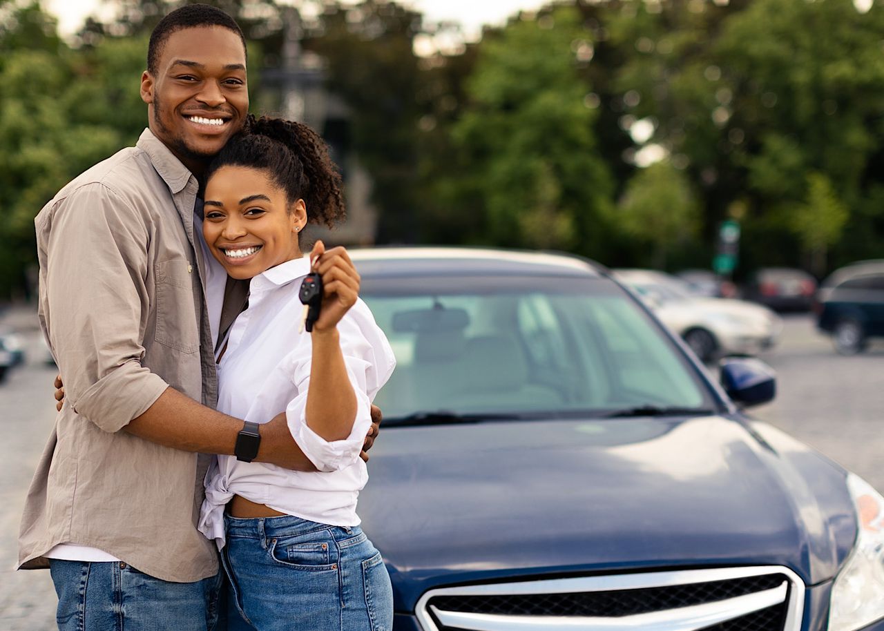 Happy African Couple Showing New Car Key Hugging Standing Outdoors by Prostock-studio