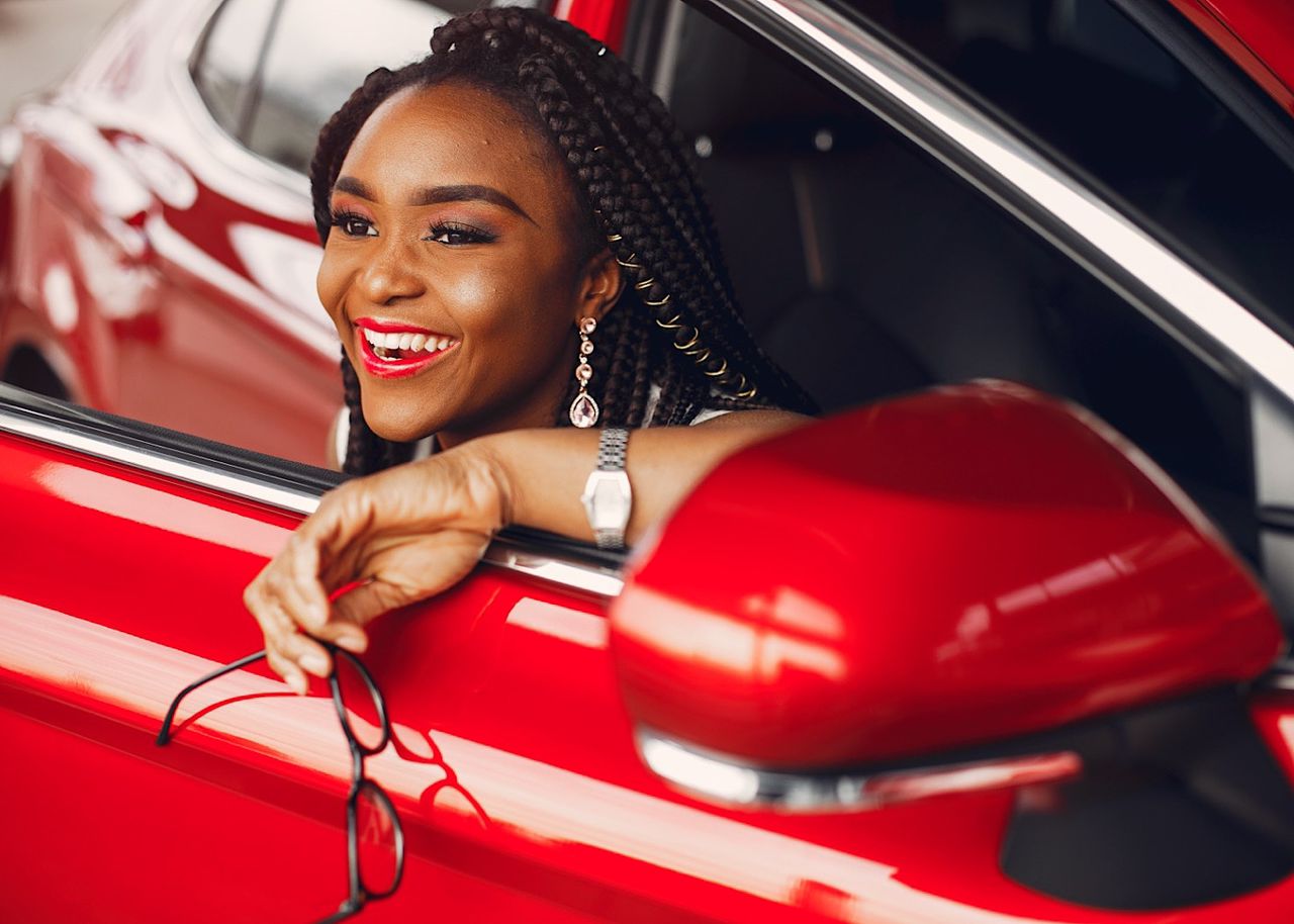 Stylish black woman in a car salon by prostooleh