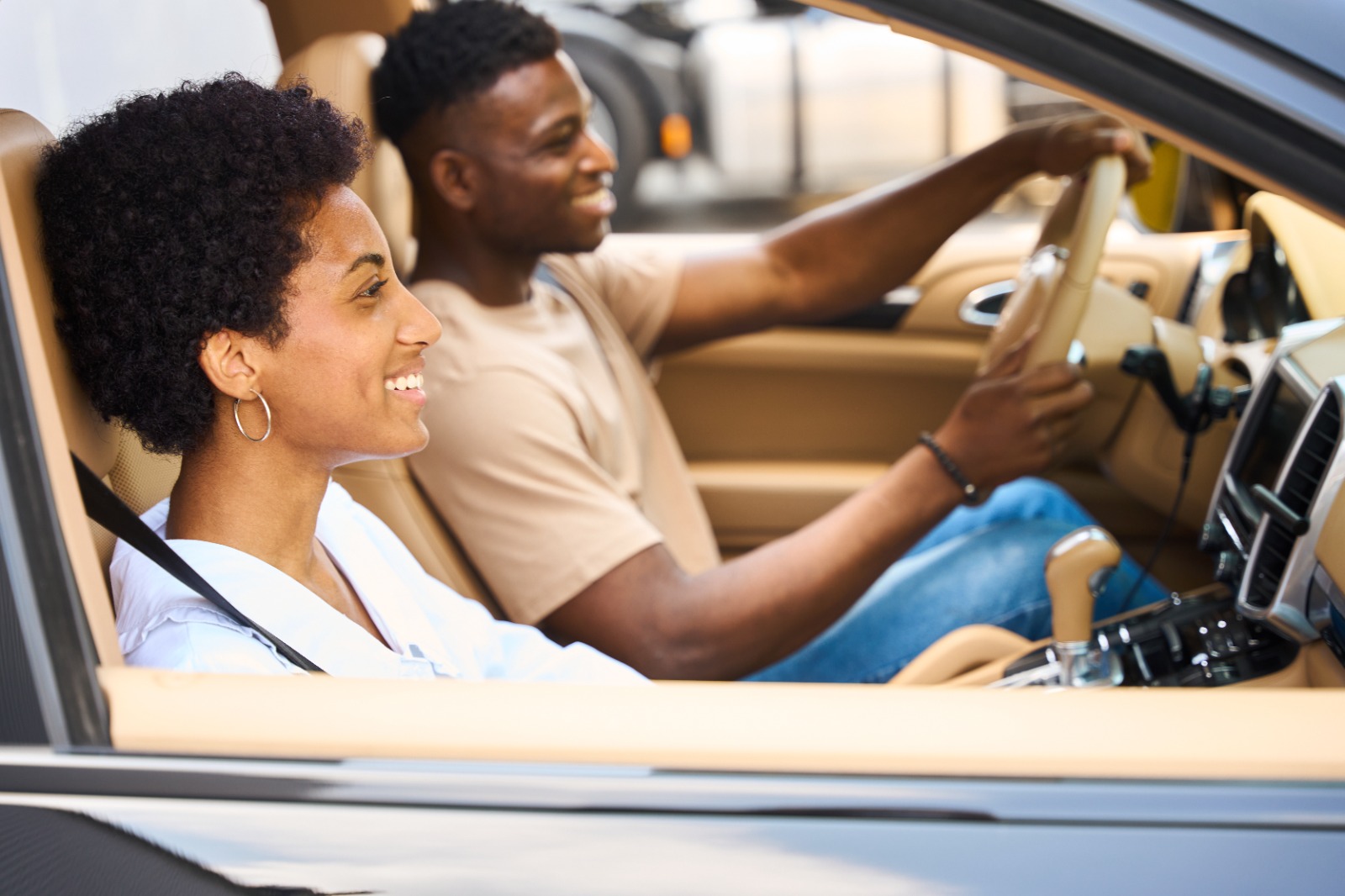 Happy African American couple traveling in a comfortable car by svitlanah