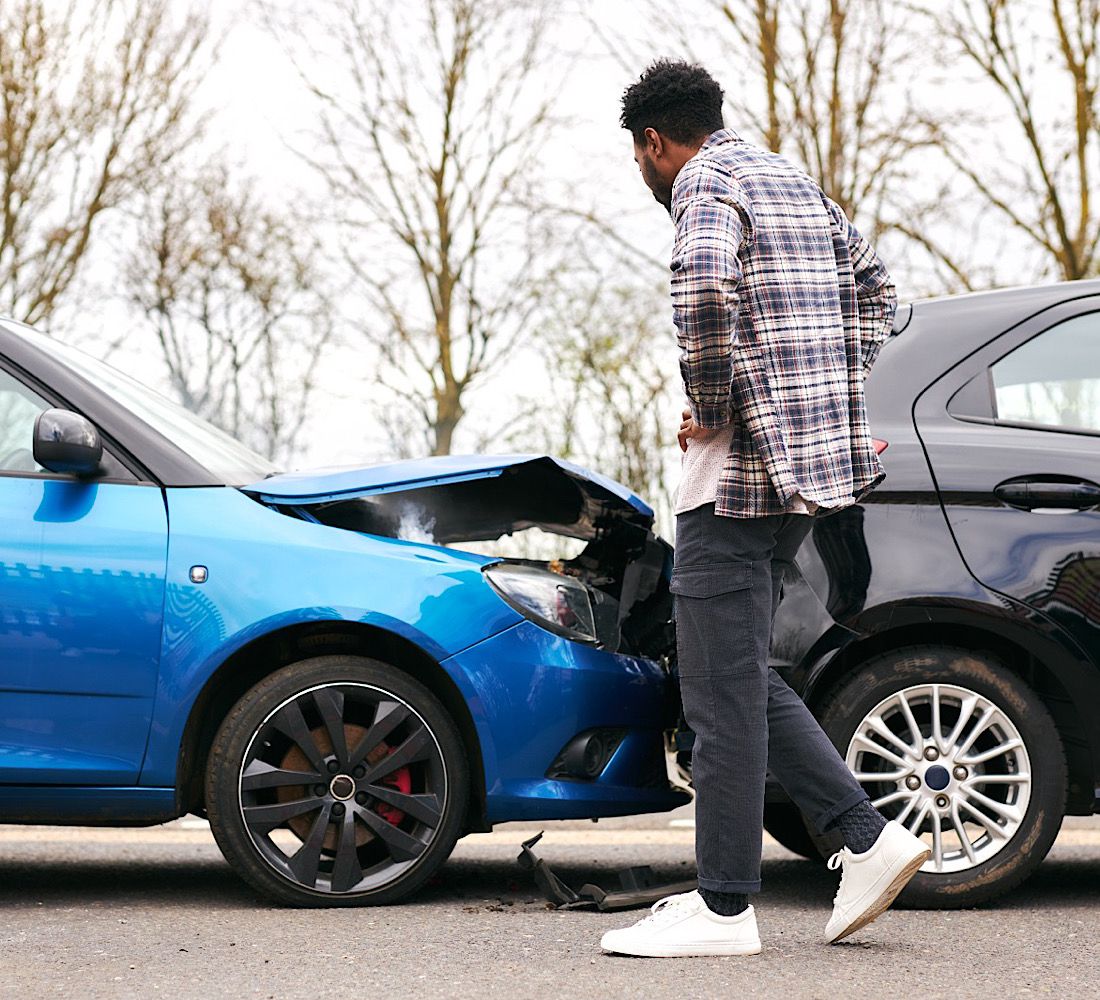 Young Male Driver Getting Out Of Car And Inspecting Damage After Road Traffic Accident by SouthworksStock