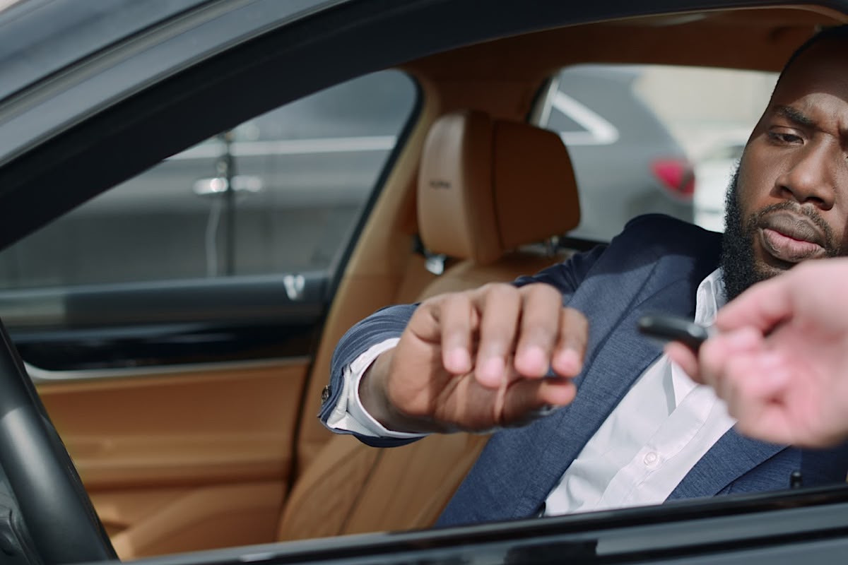 Closeup Confident African American Man Buy New Car. Cheerful Black Businessman Taking Key At by DepictionImages